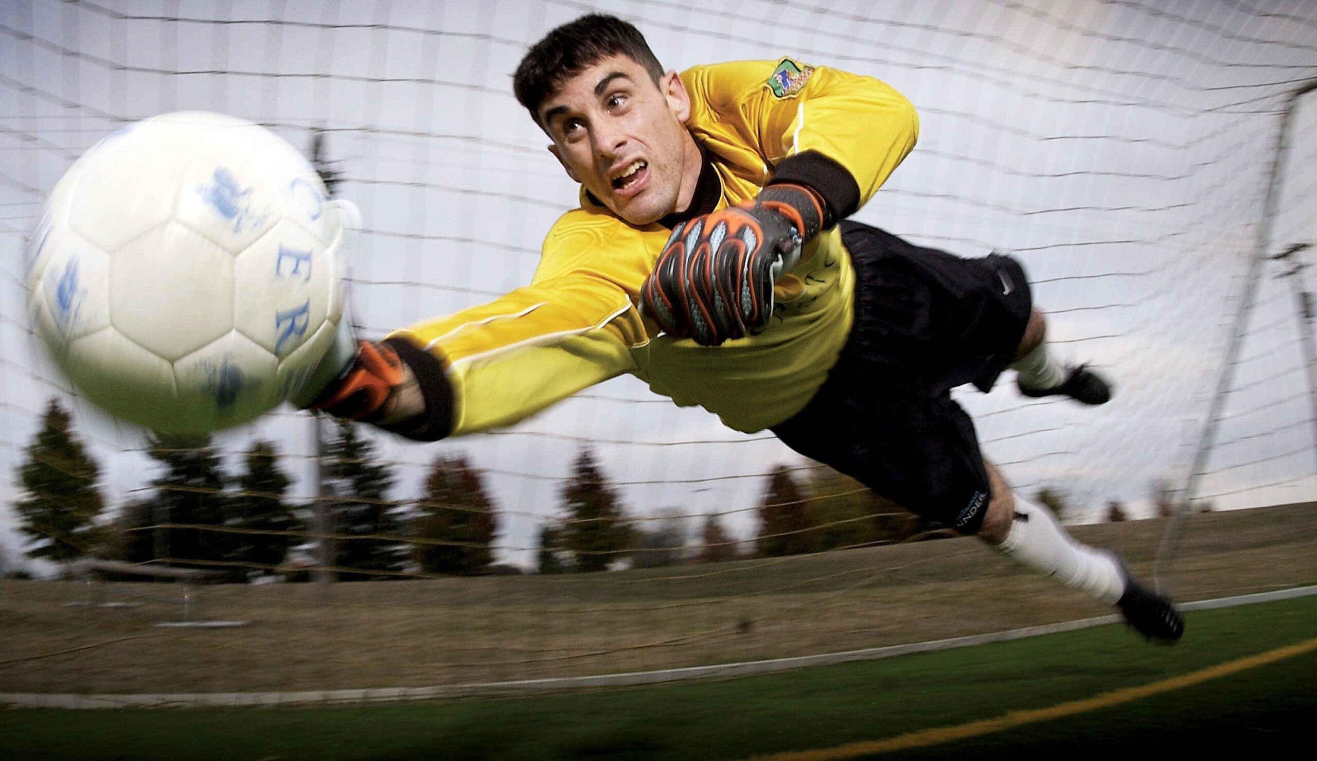 Goal keeper hitting away a ball. UWB sports performance.