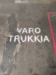 UWB digitalization. Varo Trukkia warning written with paint on a processing factory floor.